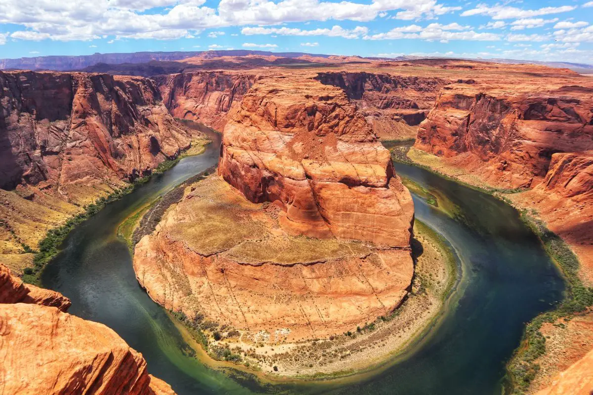 brown rock formation near river during daytime